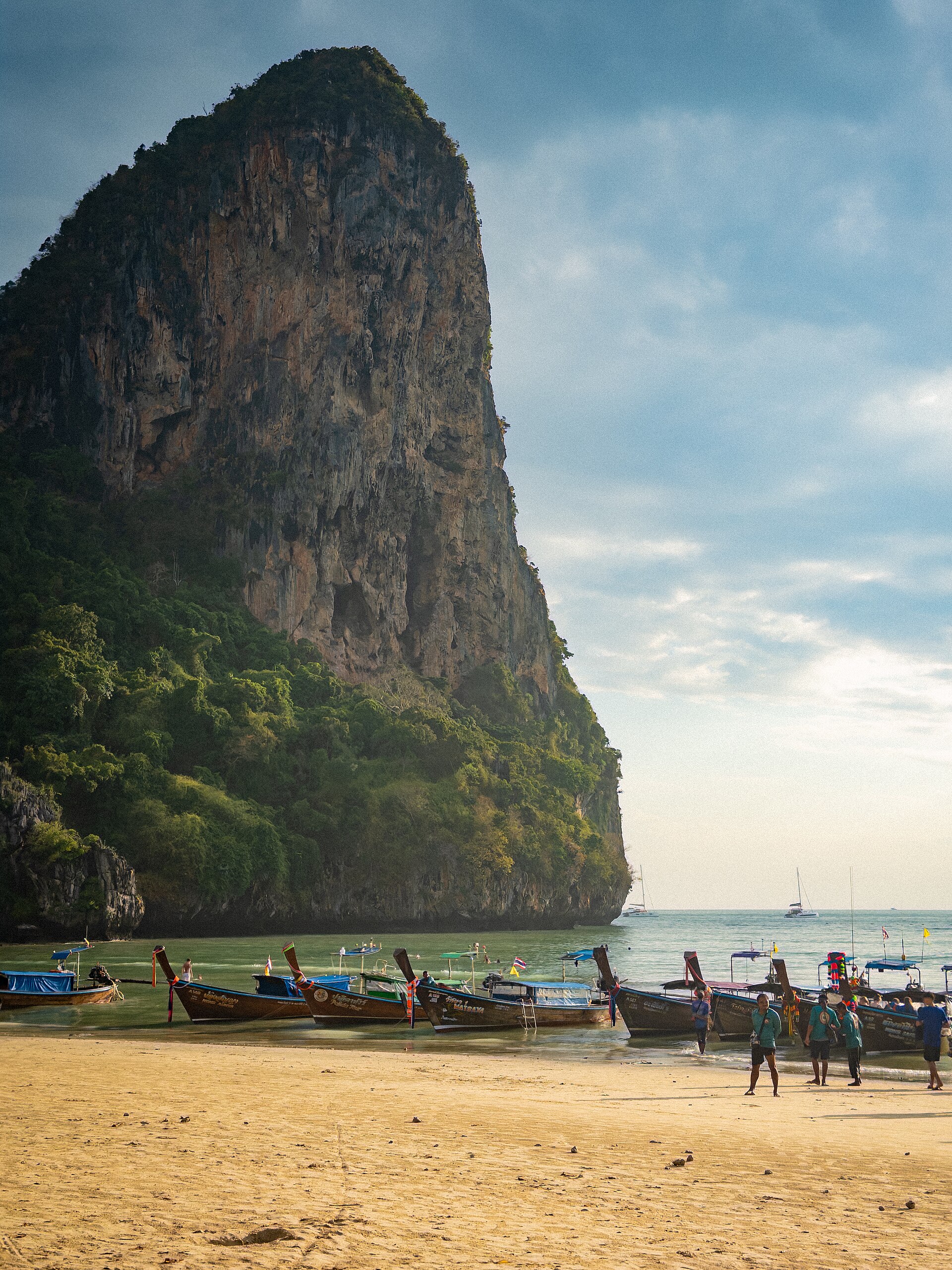 Barcos tradicionais longtail junto a falésias de calcário em Krabi